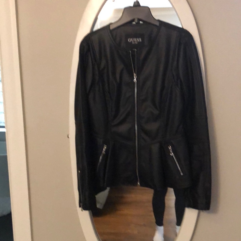 Lined faux leather peplum black coat. Side zippered pockets. Never worn.